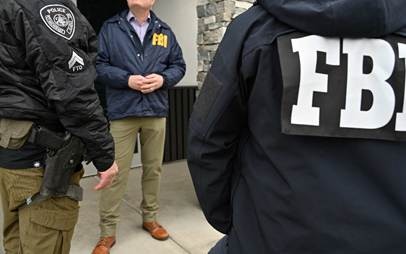 FBI Agents and Anchorage Police Officers speak outside Phoenix Spa in Anchorage.