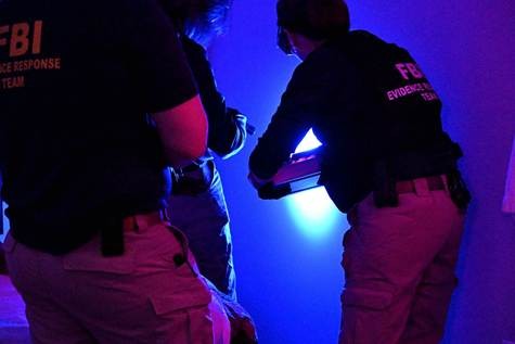 FBI Evidence Response Team members collect and document evidence.